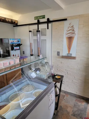 a living room with furniture a rug and a window