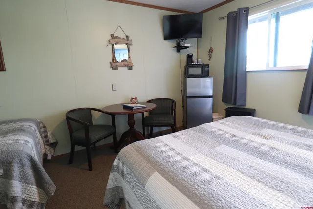 a bedroom with a bed and a chair