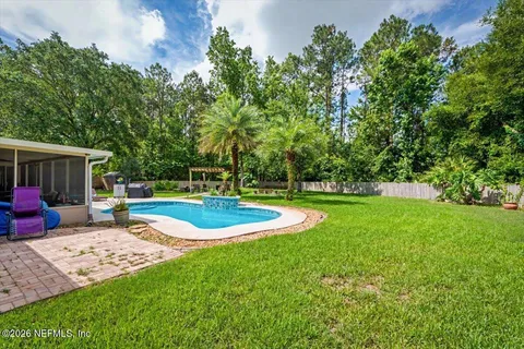 a front view of a house with swimming pool having outdoor seating