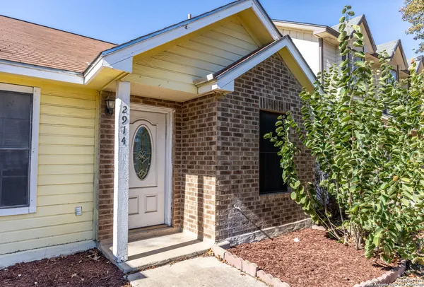a view of a house with a door and wooden walls