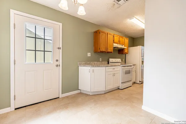 a view of a kitchen with electric appliances
