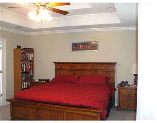 8205 Midwest Circle Corpus Christi, TX 78414 - Photo 4 of 7 a bedroom with a bed and a chandelier