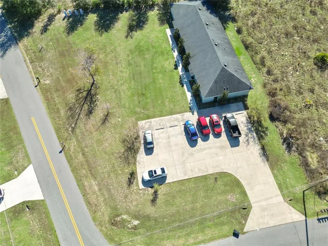 an aerial view of residential house with pool and yard