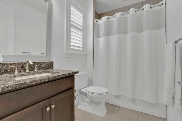 a spacious bathroom with a double vanity sink a mirror and a bathtub