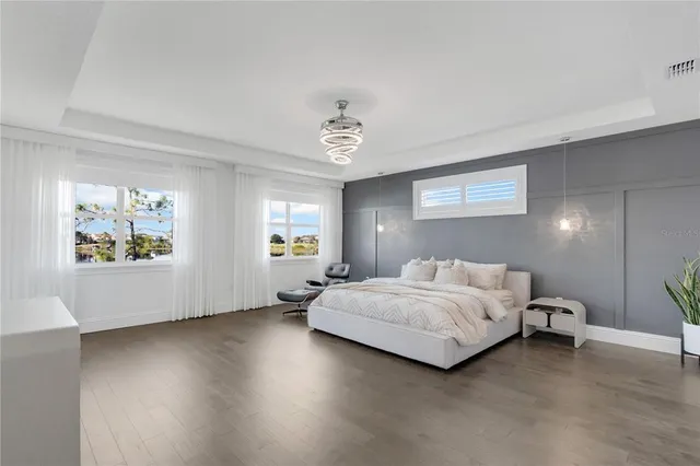 a spacious bathroom with a double vanity sink a mirror and a bathtub