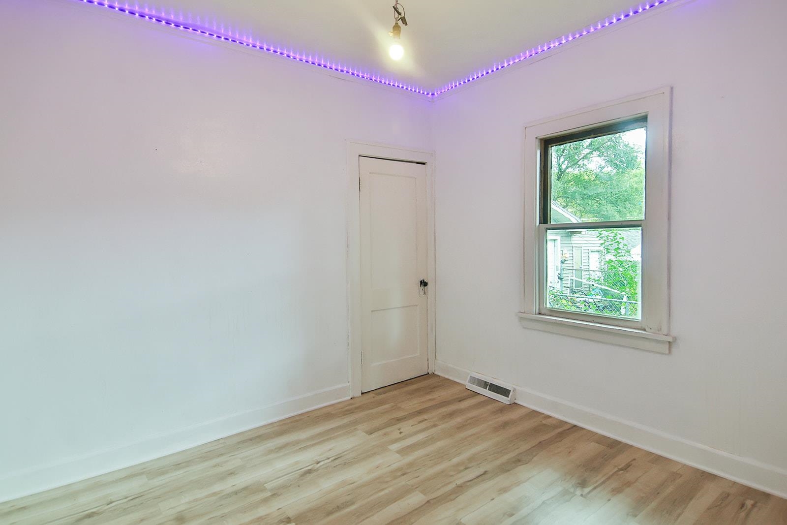 407 Barnum Road Rockford, IL 61109 - Photo 21 of 26 a view of empty room with wooden floor and fan