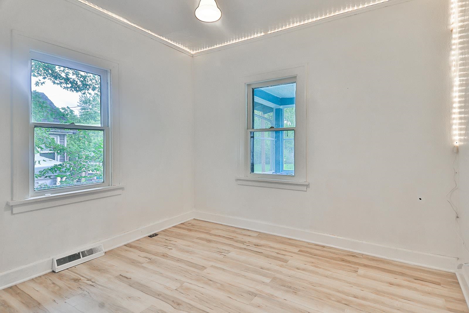 407 Barnum Road Rockford, IL 61109 - Photo 23 of 26 an empty room with wooden floor and windows