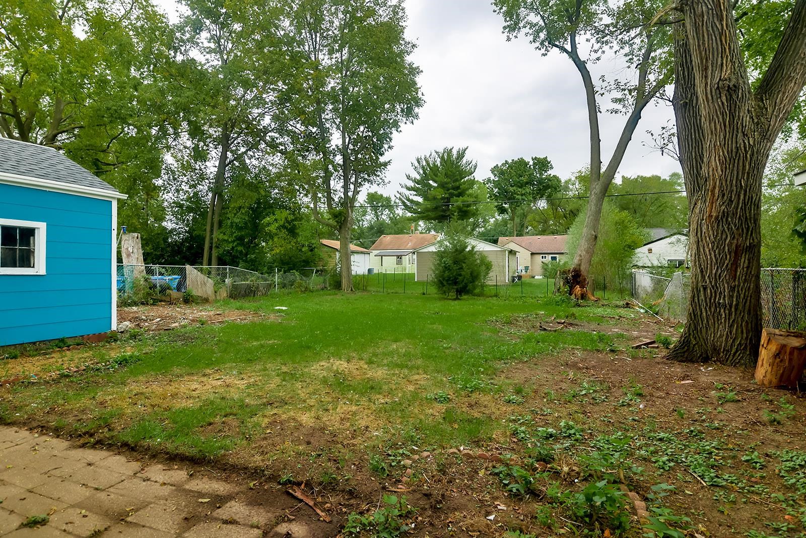 407 Barnum Road Rockford, IL 61109 - Photo 5 of 26 a view of a backyard with large trees