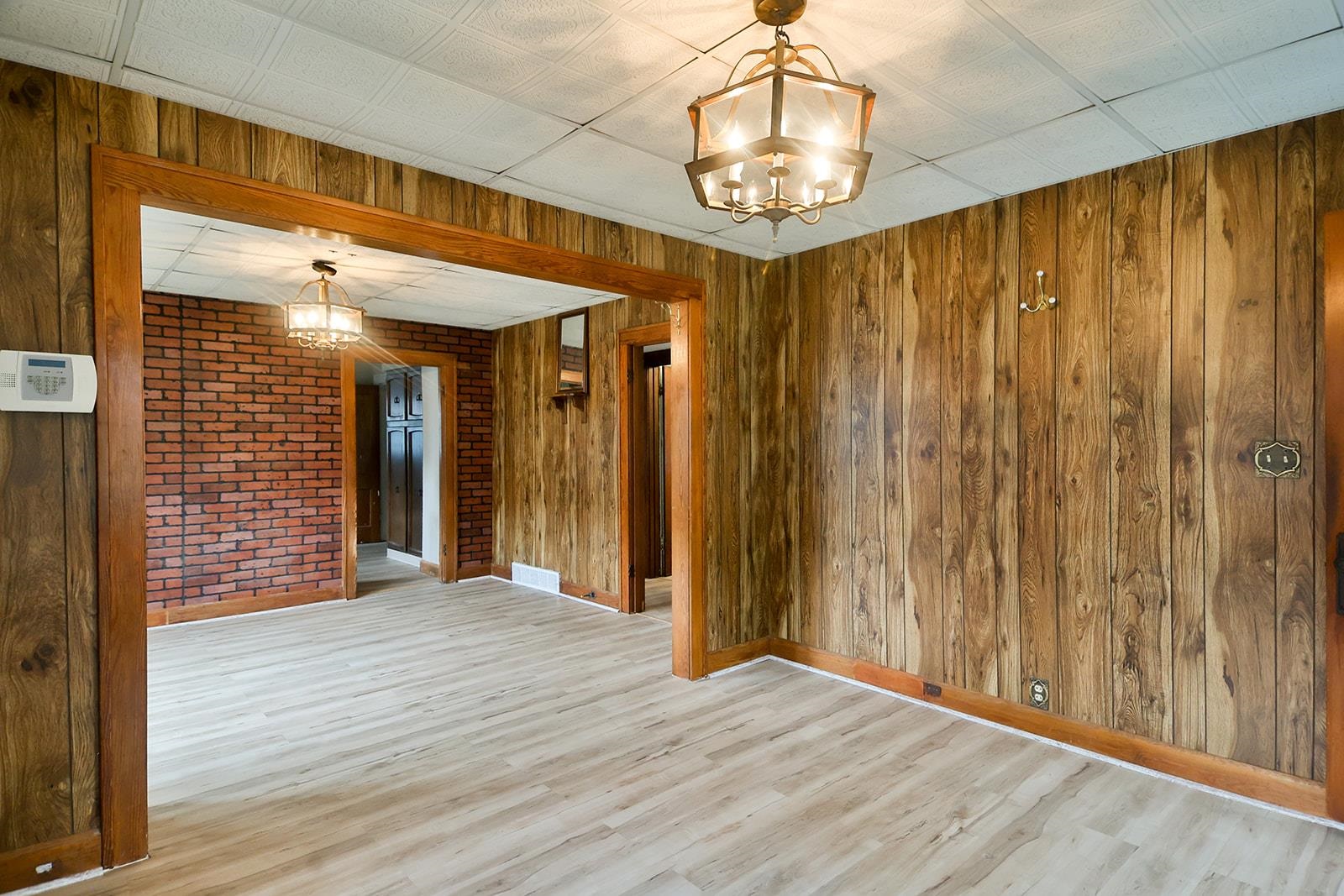 407 Barnum Road Rockford, IL 61109 - Photo 9 of 26 a view of a hallway with wooden floor and chandelier