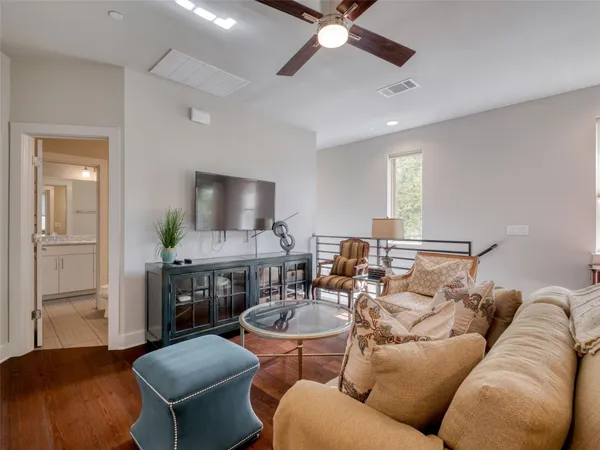 a bedroom with a bed and a ceiling fan