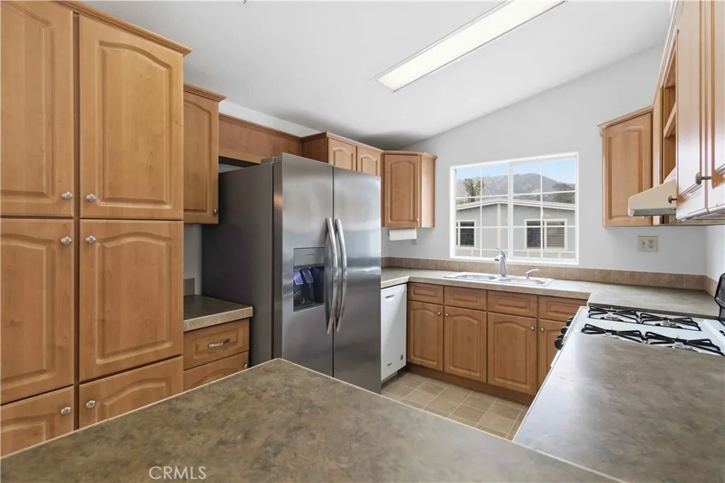 1550 Rory Simi Valley, Unit 133 Simi Valley, CA 93063 - Photo 13 of 29 a kitchen with stainless steel appliances granite countertop a refrigerator and a sink