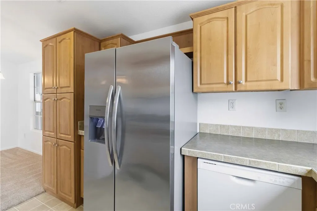 1550 Rory Simi Valley, Unit 133 Simi Valley, CA 93063 - Photo 20 of 29 a kitchen with metallic refrigerator freezer and a dishwasher