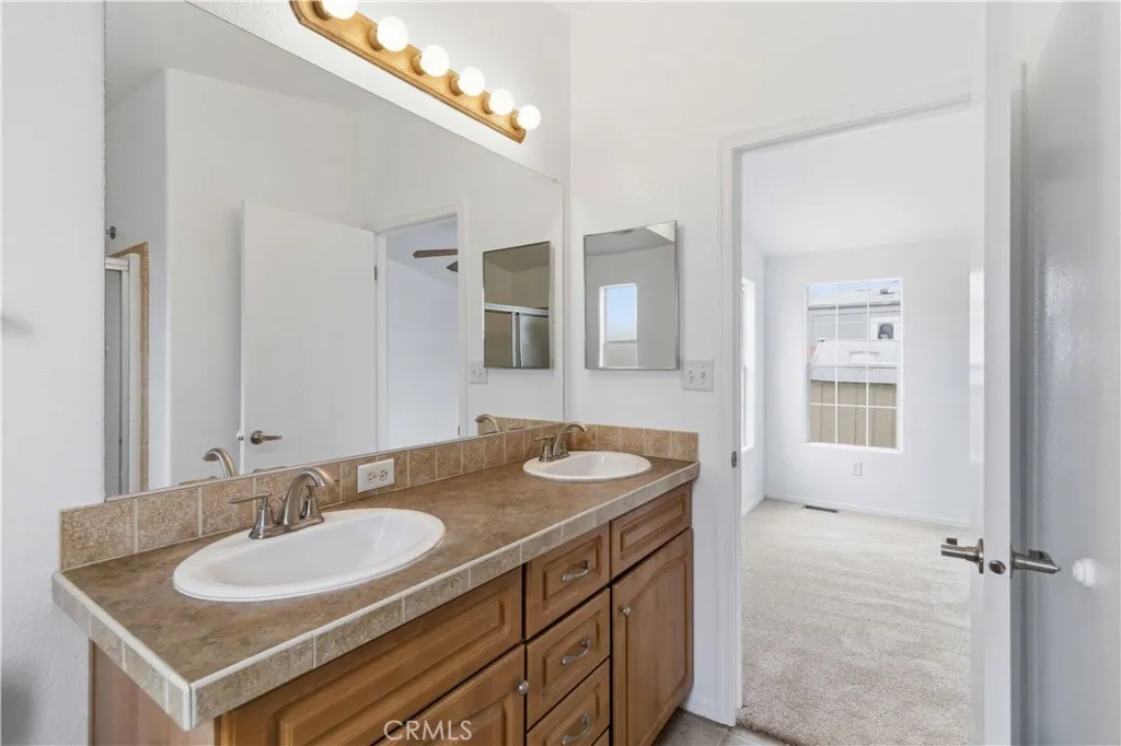 1550 Rory Simi Valley, Unit 133 Simi Valley, CA 93063 - Photo 25 of 29 a bathroom with a sink and a mirror