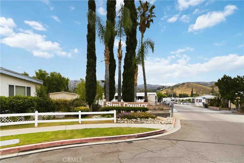 1550 Rory Simi Valley, Unit 133 Simi Valley, CA 93063 - Photo 29 of 29 a view of a swimming pool with a lawn chairs under an umbrella
