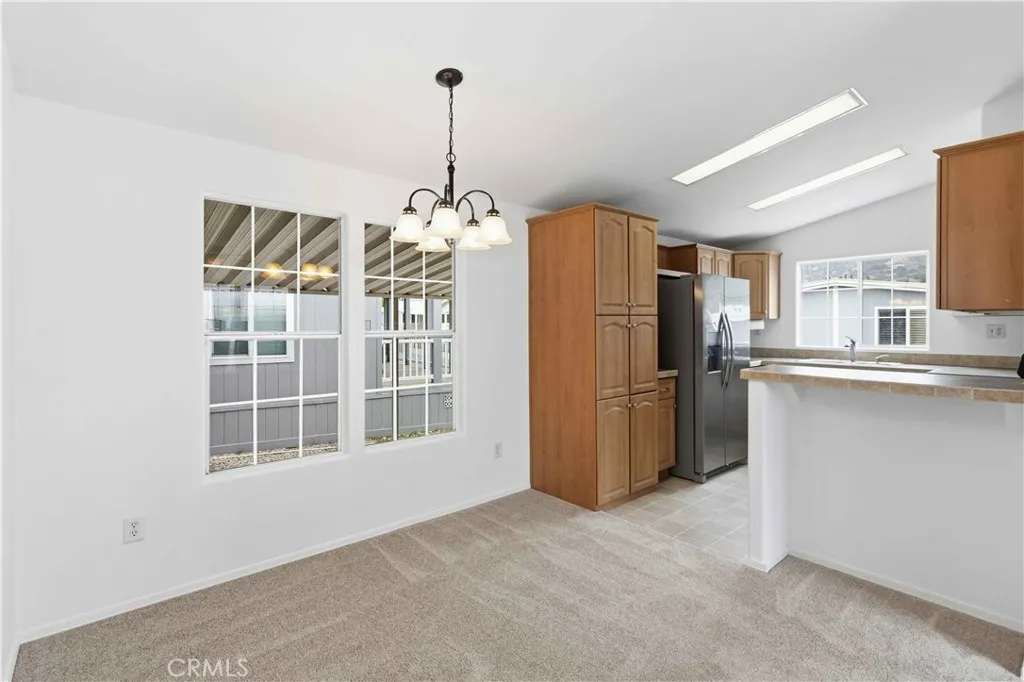 1550 Rory Simi Valley, Unit 133 Simi Valley, CA 93063 - Photo 8 of 29 a kitchen with refrigerator and window