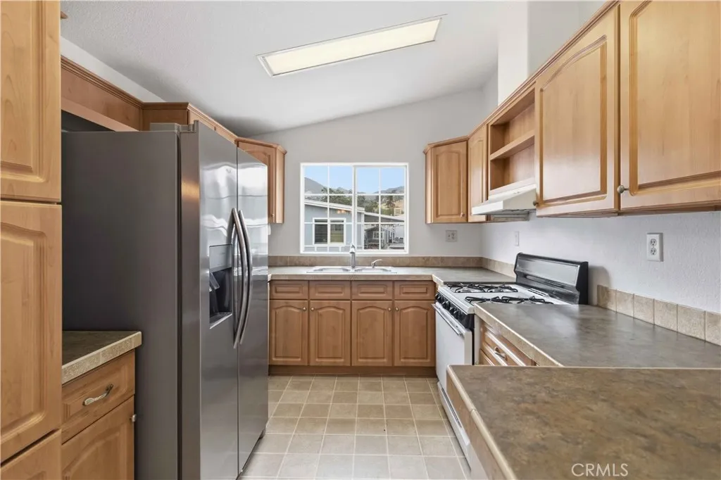 1550 Rory Simi Valley, Unit 133 Simi Valley, CA 93063 - Photo 9 of 29 a kitchen with stainless steel appliances granite countertop a refrigerator stove and sink