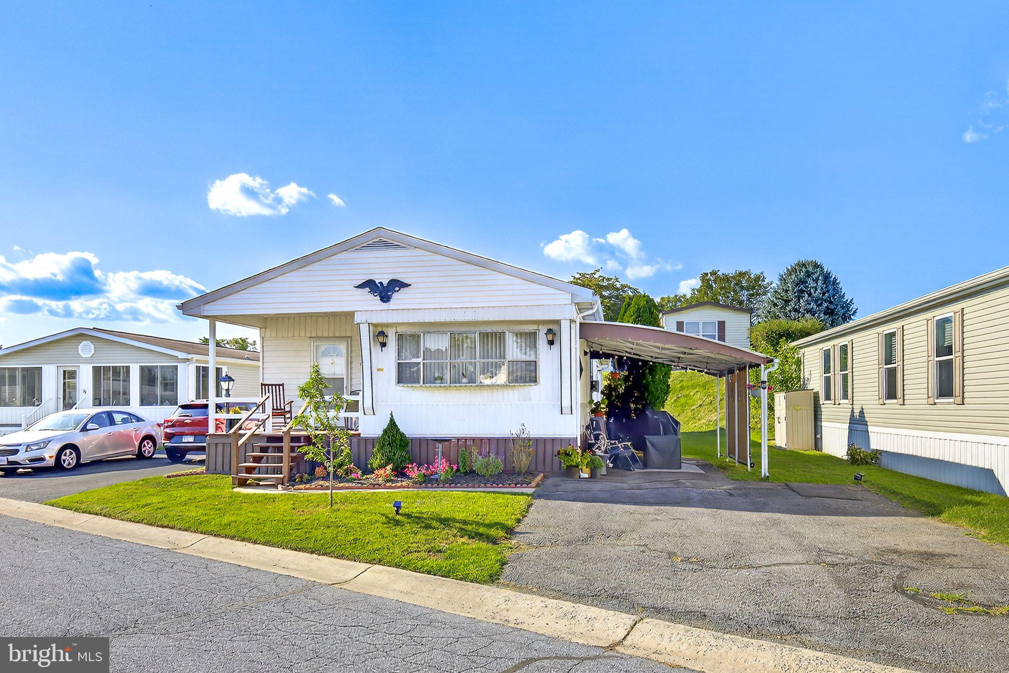77 Ridgewood Manor Manheim, PA 17545 - Photo 1 of 36 a front view of a house with a yard and a garage
