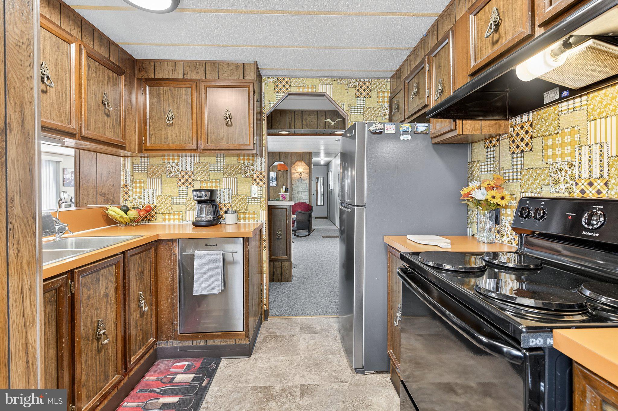 77 Ridgewood Manor Manheim, PA 17545 - Photo 16 of 36 a kitchen with stainless steel appliances granite countertop a stove a sink dishwasher and cabinets with wooden floor