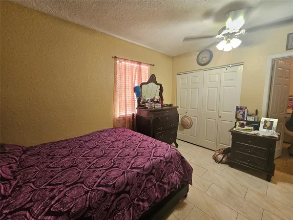 a bedroom with a bed dresser and a window