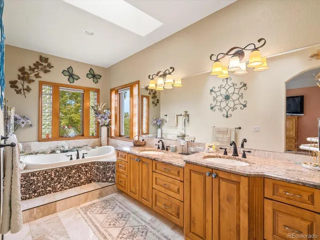 a bathroom with double vanity sinks and a bathtub