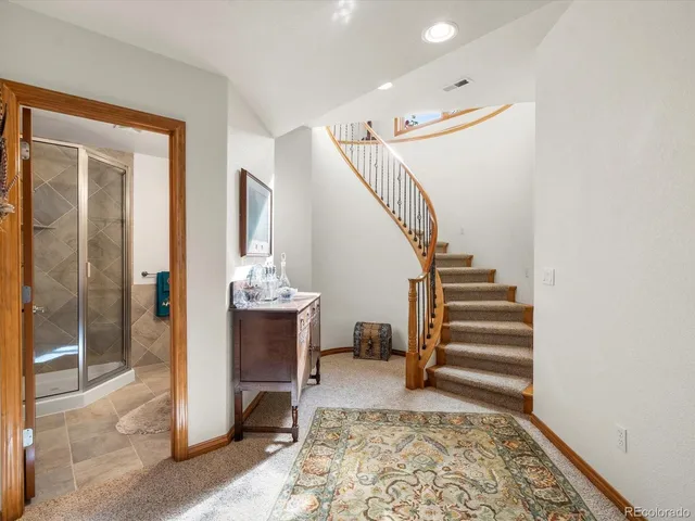 a view of a hallway with a livingroom and stairs