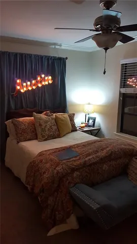 a bedroom with a bed and a chandelier