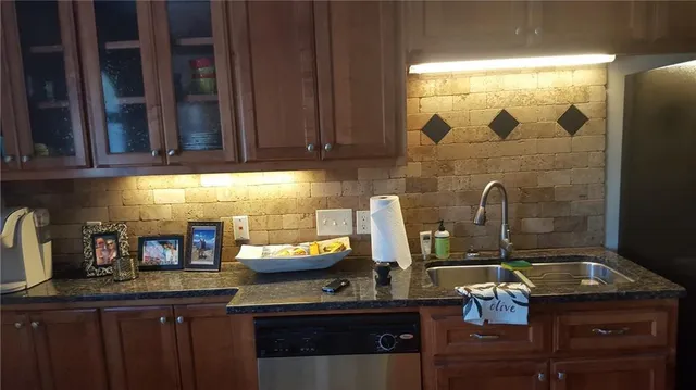 a kitchen with a sink and cabinets