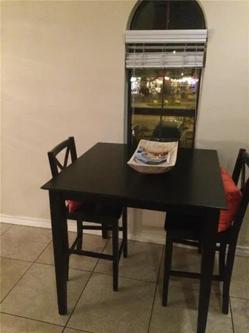 a view of a dining room with furniture and window