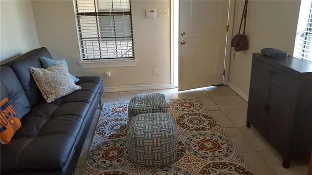 a bedroom with a couch and a window