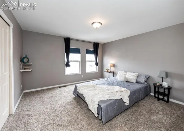 a bedroom with bed and window