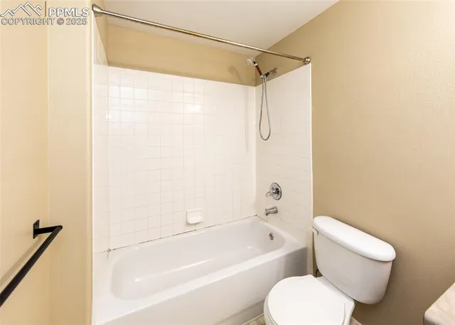 a front view of a building with large trees