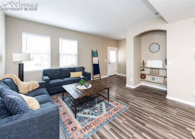 a living room with furniture and wooden floor
