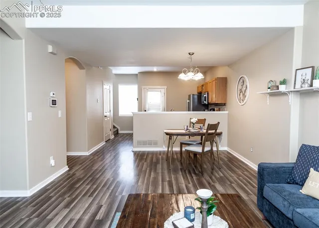 a view of a dining room with furniture and wooden floor