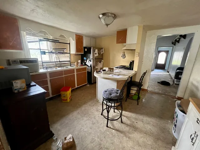 a room with furniture a air conditioner vent and a window