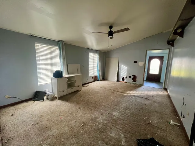 a view of livingroom with hardwood floor and a ceiling fan