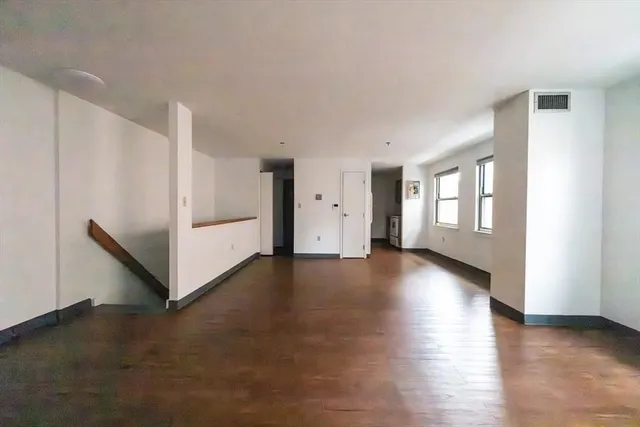 a view of a livingroom with an empty space and a window