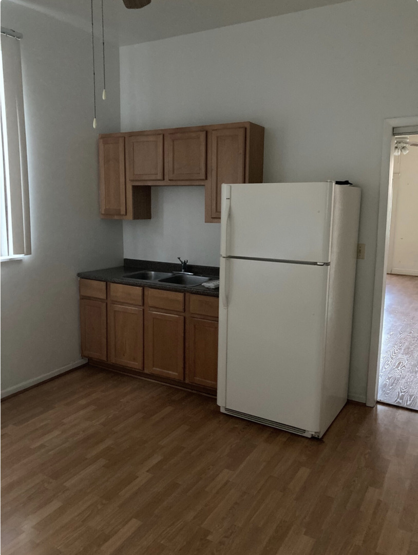 1109 South Racine Avenue Chicago, IL 60607 - Photo 10 of 29 a white refrigerator freezer sitting in a kitchen