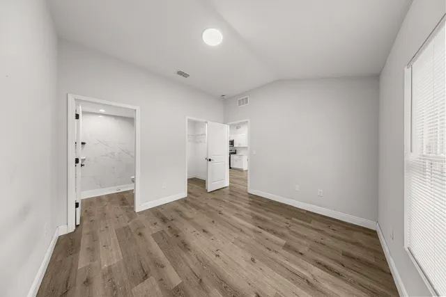 wooden floor in an empty room with a window
