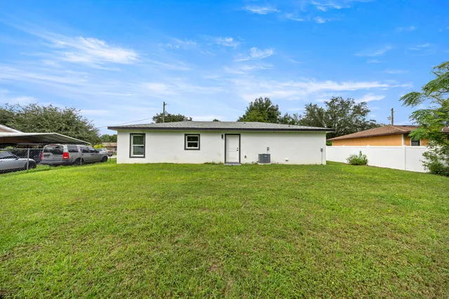 a front view of house with yard and garage