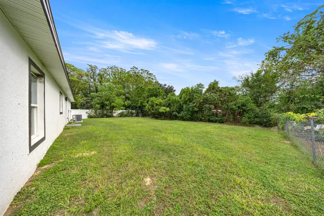 a view of a yard with a house in the background