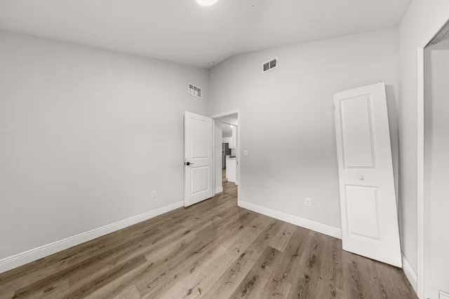 an empty room with wooden floor