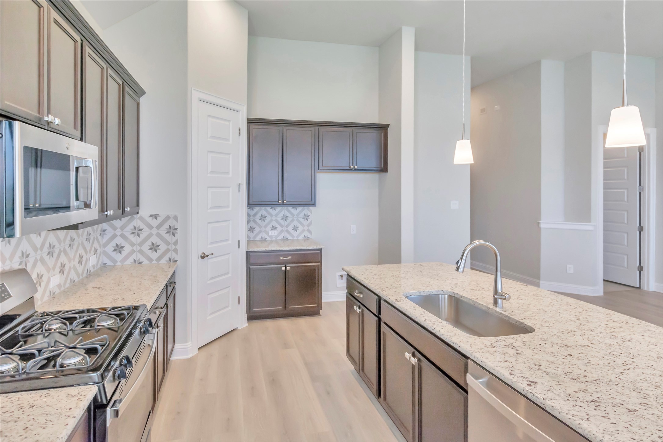 2140 Base Burner Path Leander, TX 78641 - Photo 10 of 27 a kitchen with granite countertop a sink stove and cabinets