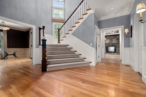 a view of entryway and hall with wooden floor