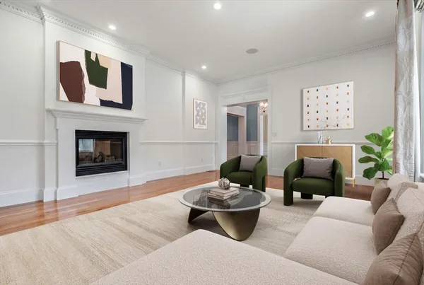 a living room with furniture potted plant and a fireplace