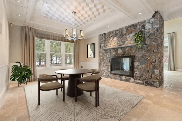 a living room with furniture a chandelier and a flat screen tv