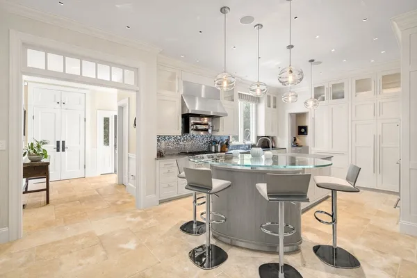 a living room with kitchen island furniture and a chandelier