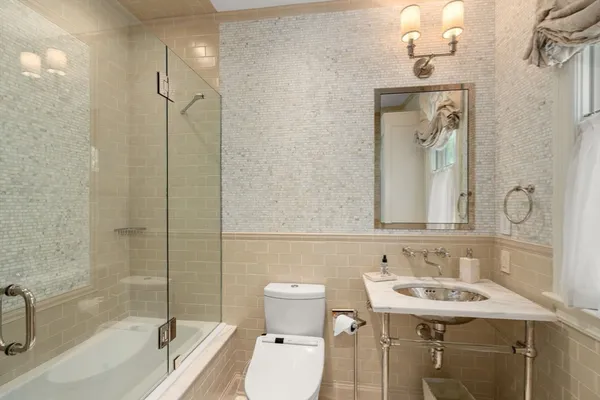a bathroom with a sink toilet and shower