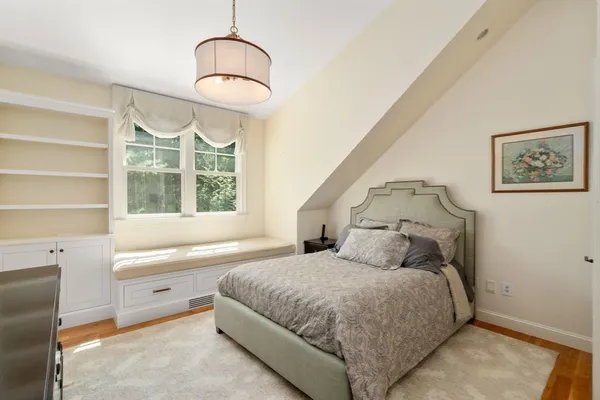 a bedroom with a large bed and a window