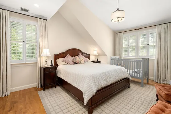 a bedroom with a large bed and a window