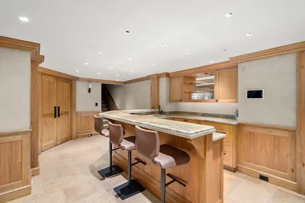 a kitchen with stainless steel appliances granite countertop a stove and a refrigerator